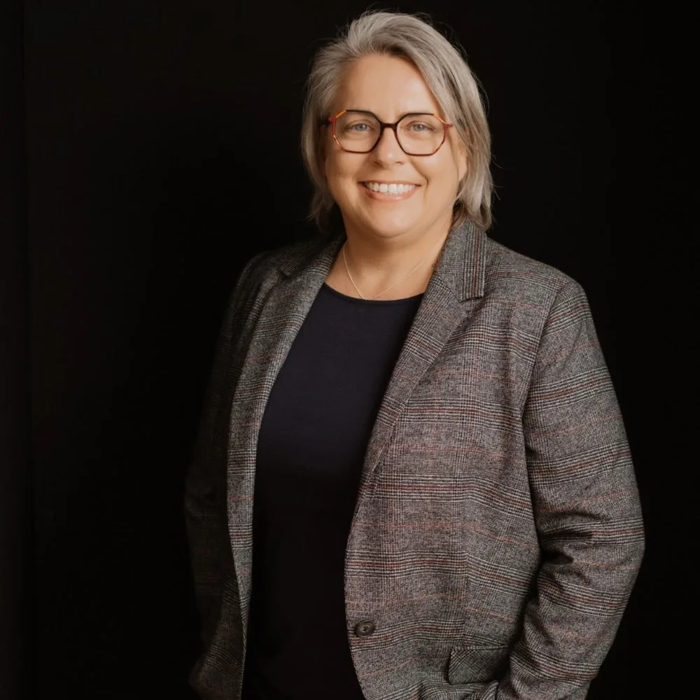Kirsten Biema in a grey checked blazer, smiling